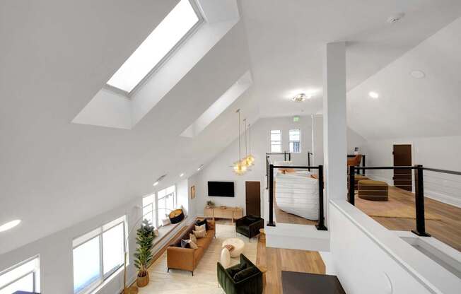 A modern living room with a skylight and a large couch.