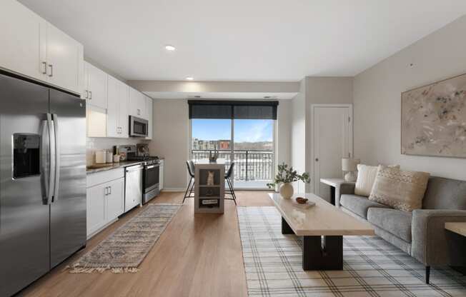 a living room with a couch and a table and a refrigerator