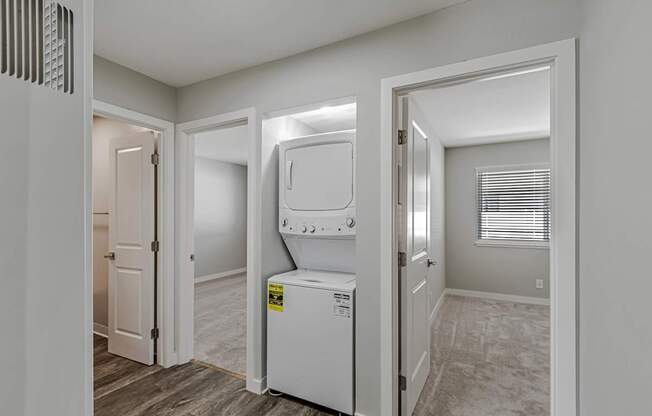 A white washing machine is in a laundry room.