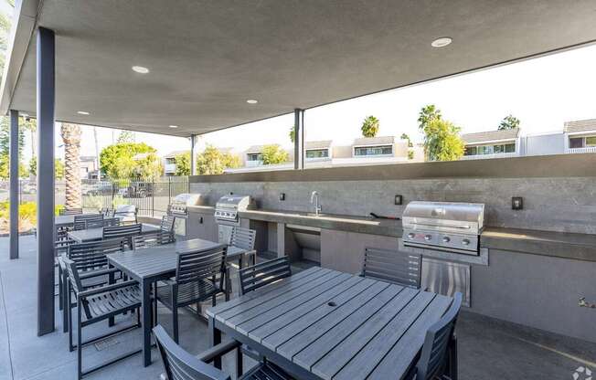 A patio with a grill and seating area.