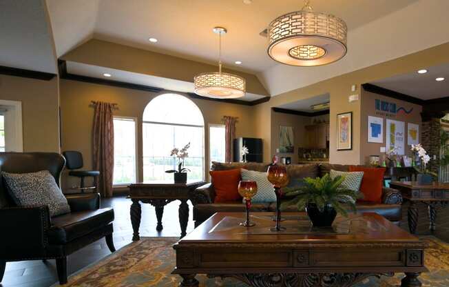 A living room with a brown sofa and a wooden coffee table.