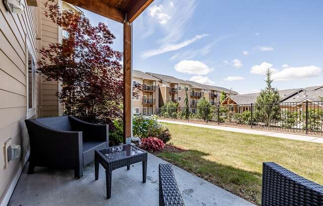 Patio with view of grass and clubhouse