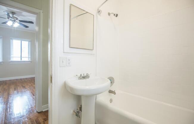 a white sink sitting under a window