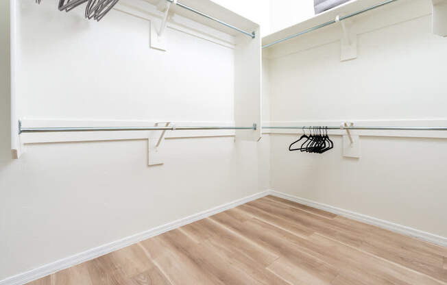 A room with a white wall and a wooden floor.