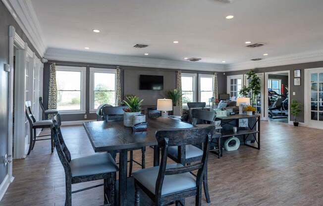 a large living room with a large table and chairs