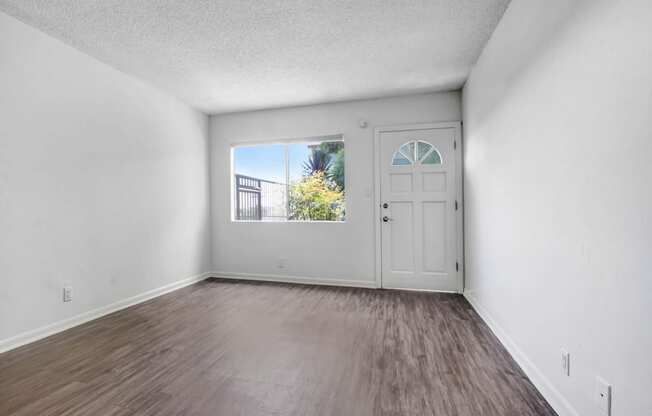 an empty room with a door and a window