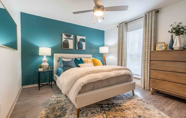 The Jaunt Apartments in Charleston South Carolina photo of a bedroom with a bed and a ceiling fan