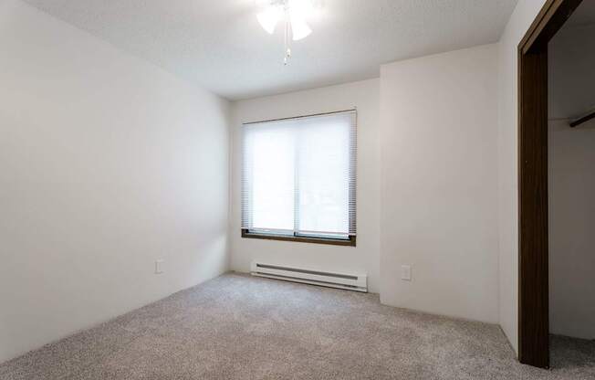 A room with a window and a carpeted floor. at Bristol Ridge, Iowa, 50322