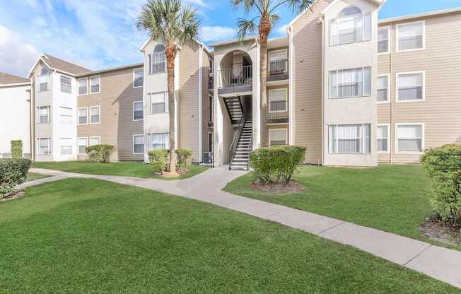 Apartment complex with a green lawn in front.