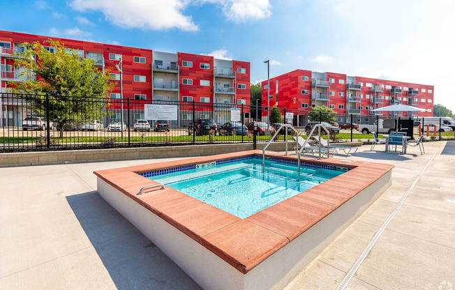 our apartments offer a swimming pool with a city building in the background