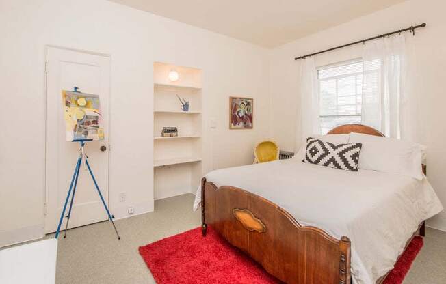 a bedroom with a bed and a window at MILEPOST 5 Apartments, PORTLAND, OR