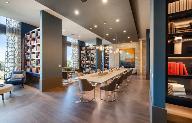 a dining room with a long table and chairs in a library