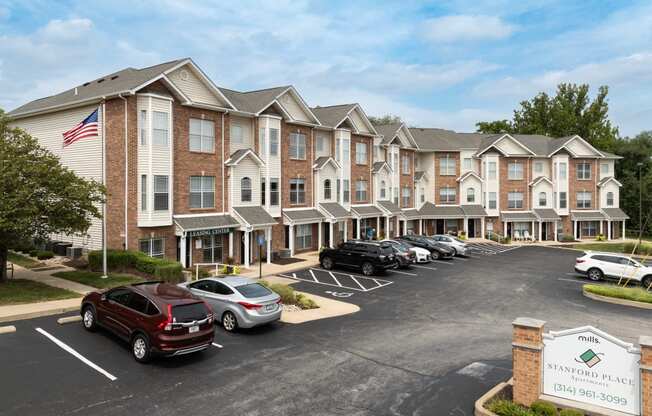 an apartment building with cars parked in front of it