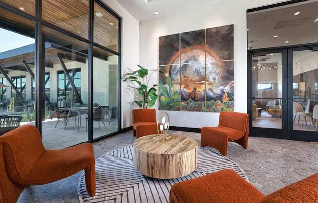 A room with a large mural of a planet and a wooden table with chairs.