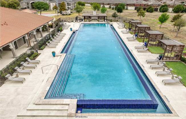 swimming pool with sundeck and lounge chairs at Villages 3Eighty apartments