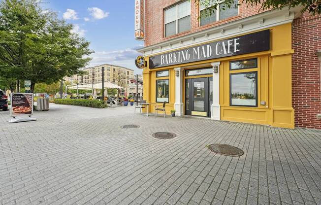 A brick building with a yellow front and a sign that says
