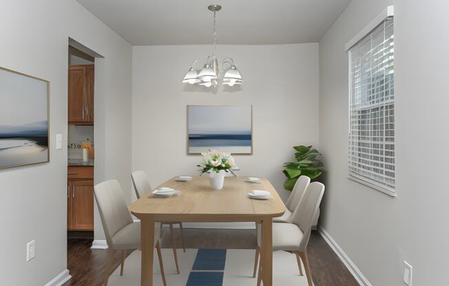 a dining room with a table and chairs and a chandelier