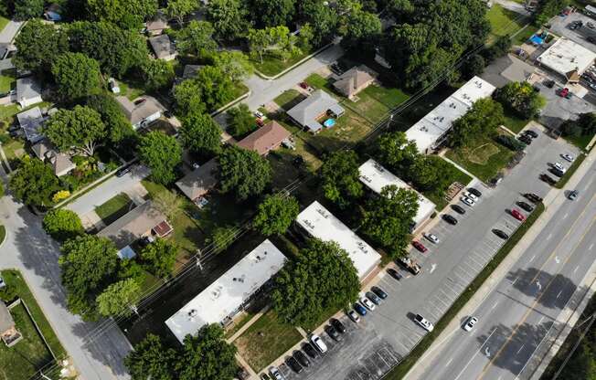 an aerial view of a neighborhood with cars and trees