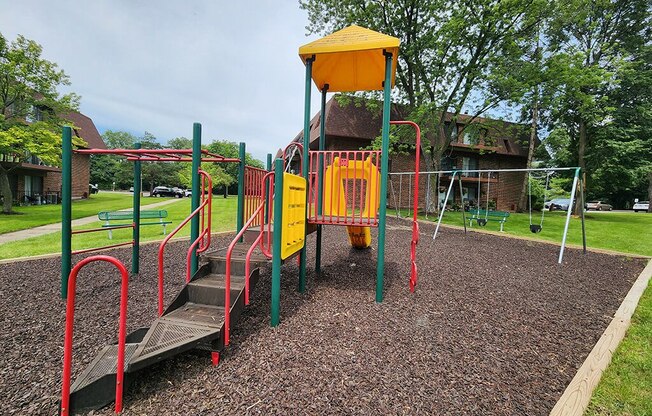 a playground with a swing set in a park