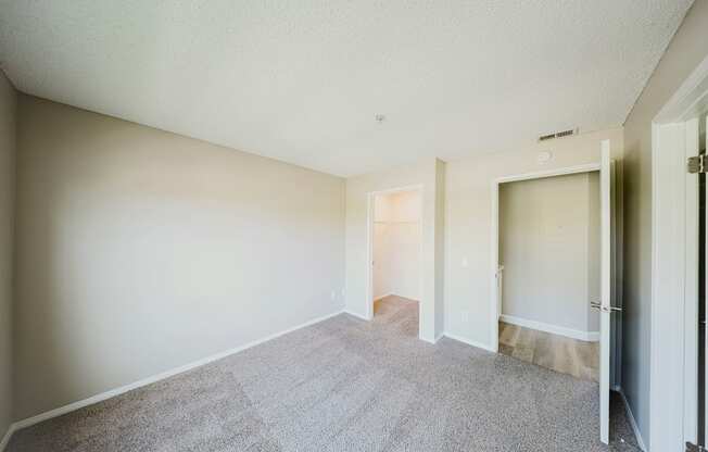 A room with a carpeted floor and white walls.
