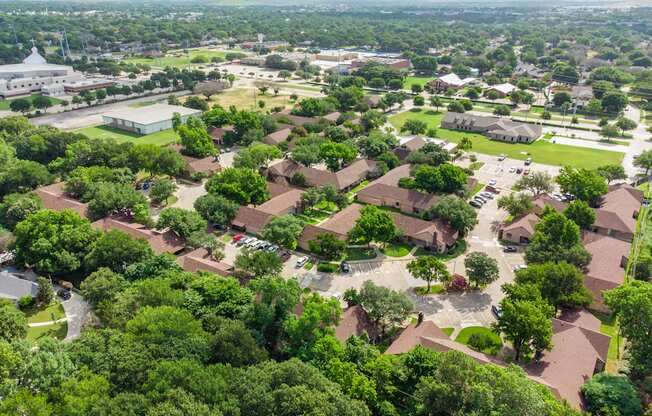 A bird's eye view of a residential area with houses and trees.