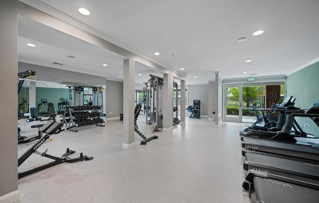 Fitness center with cardio and strength-training equipment, open workout areas, and ample room to support a variety of fitness routines.