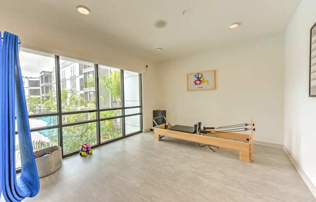 a room with a ping pong table and a large window at Pinnacle Apartments, Jacksonville, 32256