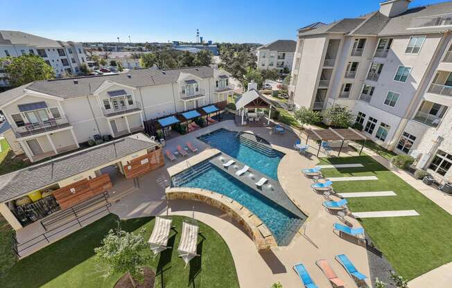 an aerial view of an apartment complex with a swimming pool