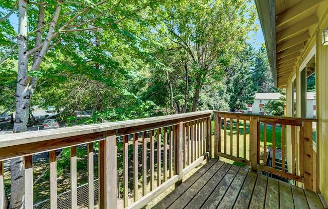 a large deck with a view of the trees