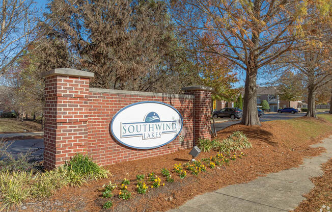 A sign that says Southwind Lake in front of a tree.