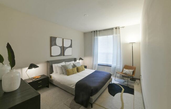 a bedroom with a large bed and a window