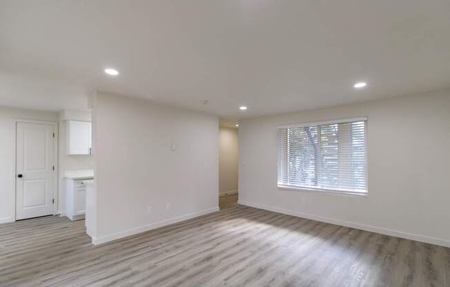 Open living space with plank flooring at Melrose on 91 in Redmond, WA