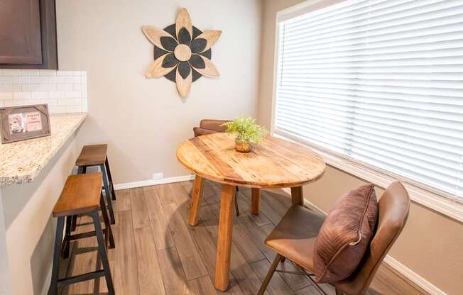 A brown chair sits in front of a wooden table.