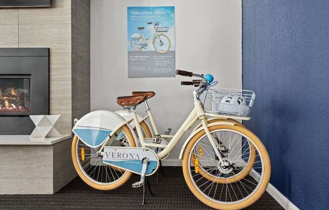 a bike parked next to a wall in a lobby at Verona, Littleton, CO