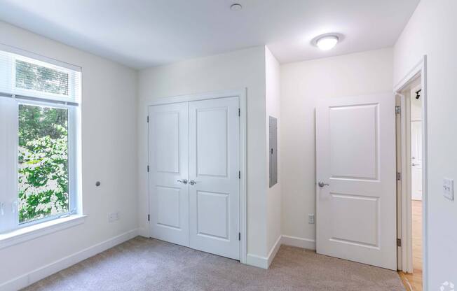 A bedroom with a window and spacious closets at 7 Cameron Apartments, Cambridge