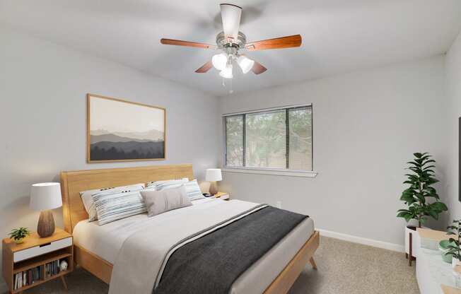 a bedroom with a large bed and a ceiling fan