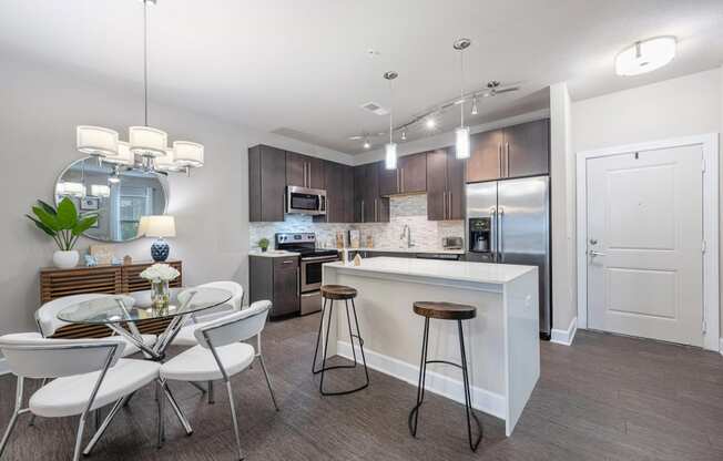 a kitchen and dining area with a table and chairs
