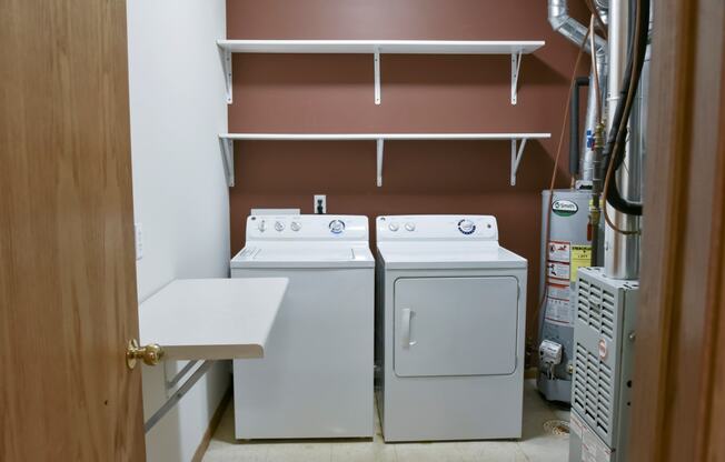 Laundry room with full size washer and dryer and shelving