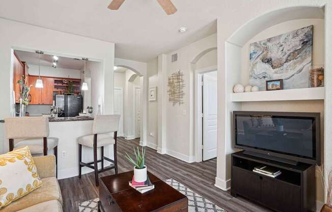 A living room with a brown coffee table and a flat screen TV.