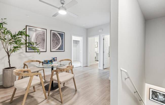 a dining room with a glass table and chairs