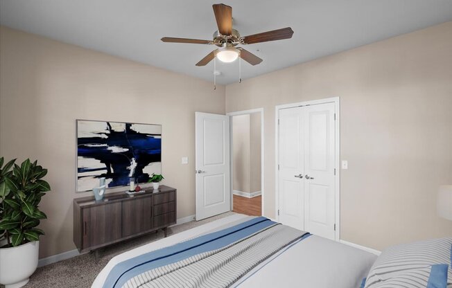 a bedroom with a bed and a ceiling fan