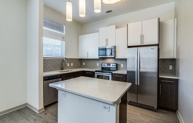Rowlett, TX Apartments for Rent - Harmony Luxury Apartments Kitchen with Stainless Steel Appliances and Granite Countertops