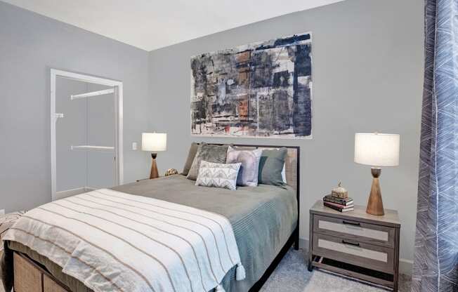 a bedroom with a bed and a painting on the wall