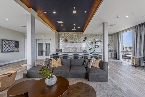 a living room with a gray couch and a table