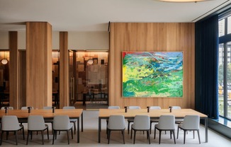 a shared amenity conference room table and chairs and a painting on the wallat Book Tower, Michigan, 48226