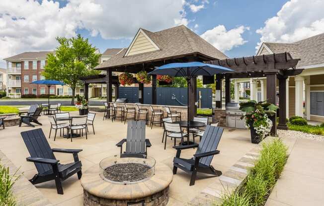 an outdoor patio with tables and chairs and a pavilion with umbrellas