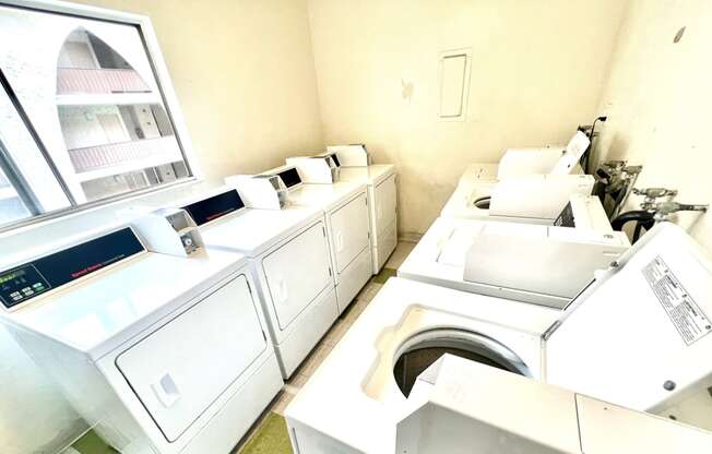 Laundry facility featuring four washing machines and four dryers 