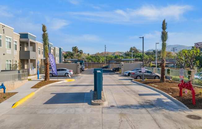 a parking lot at the whispering winds apartments in pearland, tx at Loma Villas Apartments, San Bernardino California