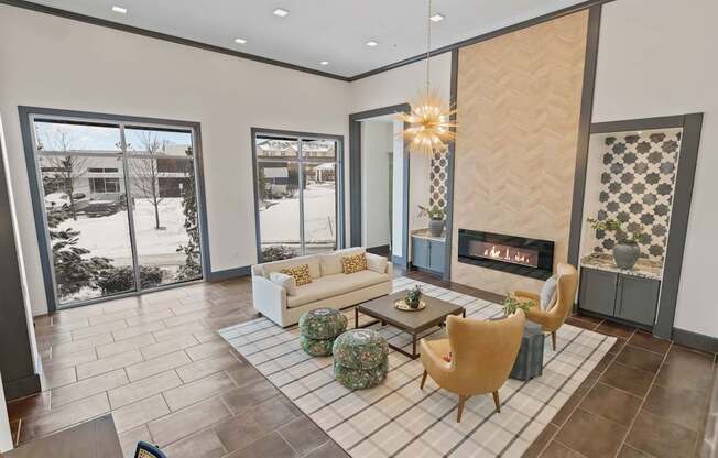 A living room with a fireplace and a large window.