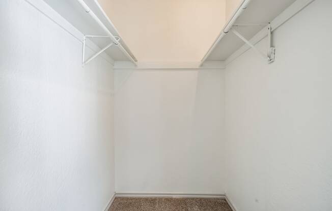 an empty room with white walls and a carpeted floor